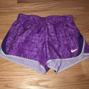 NIKE kids running shorts in purple pixels